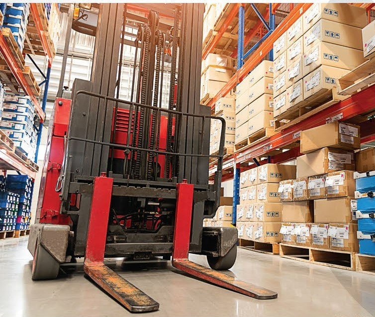 A forklift sits in a warehouse